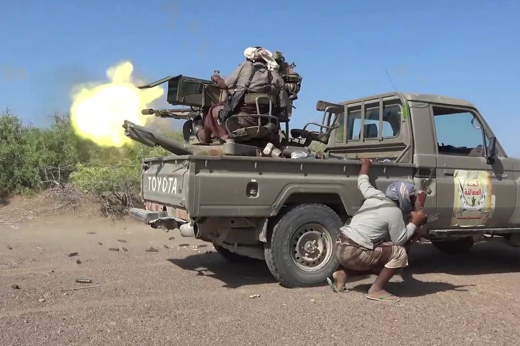 Pro-Yemeni government fighters fire from the back of a ‘technical’ vehicle during clashes with Houthis in Taiz province. Photo: Yemen Giants Brigades Media Centre via AFP