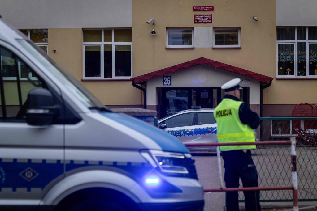 Police officers stand in front of the school where a 15-year-old fatally stabbed the caretaker of his former school and wounded two others in Leszczydol-Nowiny, Poland, on Thursday. Photo: AFP Police officers stand in front of the school where a 15-year-old fatally stabbed the caretaker of his former school and wounded two others in Leszczydol-Nowiny, Poland, on Thursday. Photo: AFP
