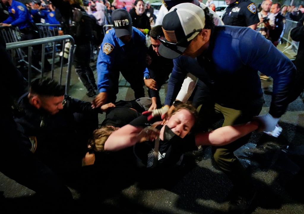 Police detain a protester in the wake of the shooting. Photo: Reuters