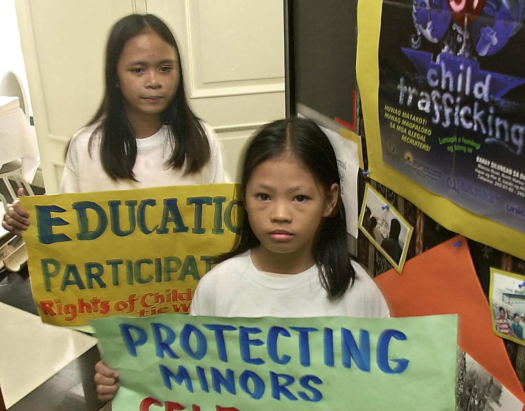 Filipino children who were rescued from domestic work carry placards urging governments to eliminate child labour and protect children’s rights during a forum in Manila in 2002. Photo: AFP
