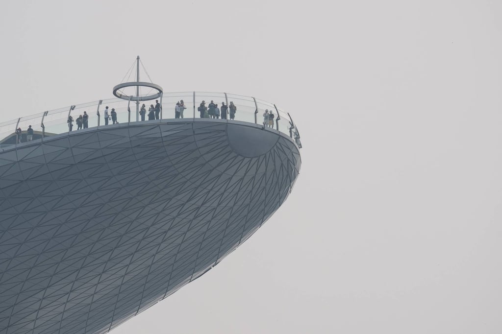 People stand on the observation deck of the Marina Bay Sands on a hazy day in Singapore on Thursday. Photo: AFP