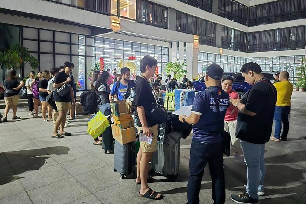 Foreign workers gather outside a raided scam complex in Bamban, Tarlac province, in 2024. Photo: PAOCC/AFP Foreign workers gather outside a raided scam complex in Bamban, Tarlac province, in 2024. Photo: PAOCC/AFP