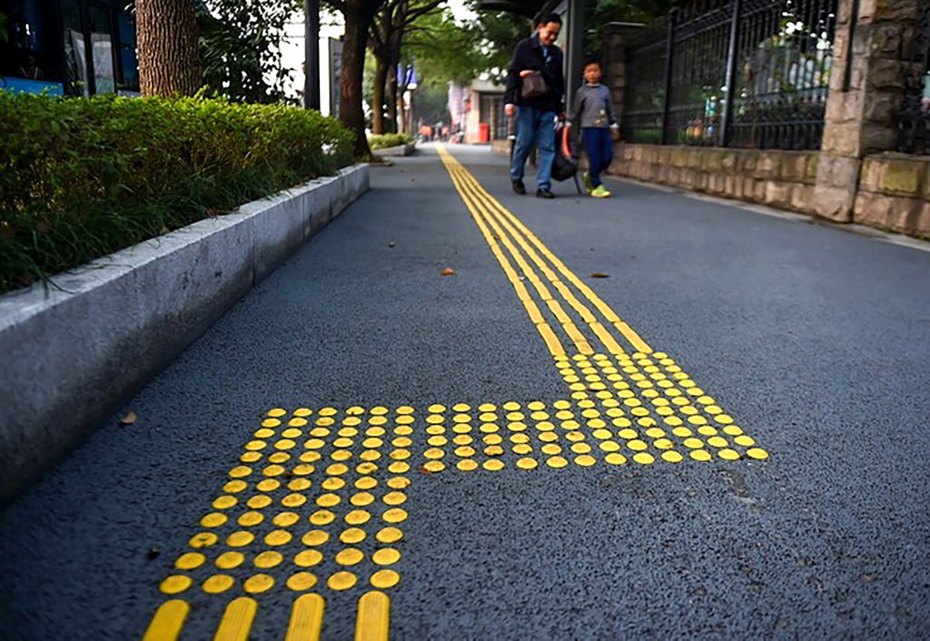 The photo above shows a tactile pedestrian lane designed for blind individuals, highlighting an essential feature for the millions of visually impaired people living in China. Photo: Xinhua The photo above shows a tactile pedestrian lane designed for blind individuals, highlighting an essential feature for the millions of visually impaired people living in China. Photo: Xinhua