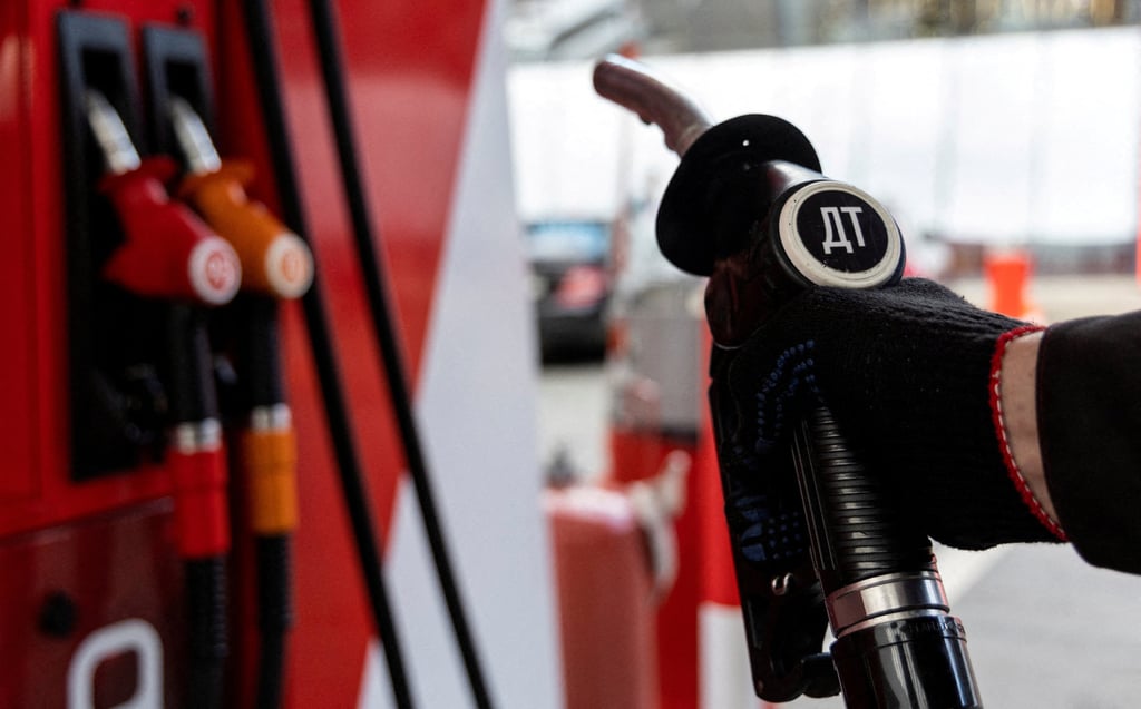 An employee holds a diesel fuel pump nozzle at a petrol station in Moscow, Russia, in September. Photo: Russia
