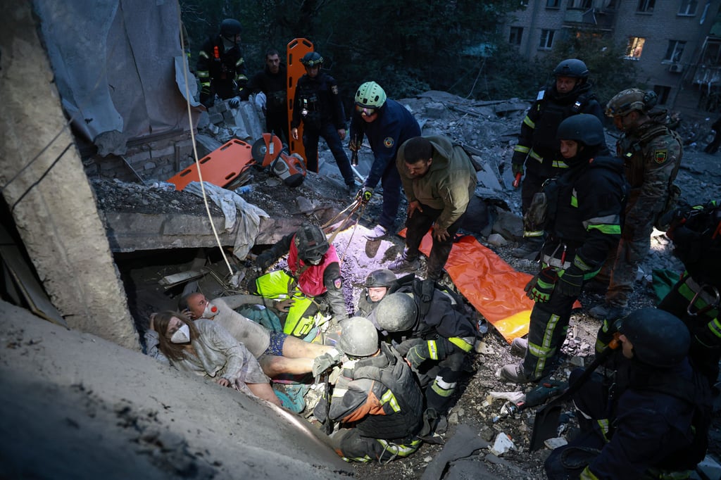 Rescue workers pull a family from the rubble of a residential building destroyed by a Russian air strike in Zaporizhzhia, Ukraine, on Saturday. Photo: AP