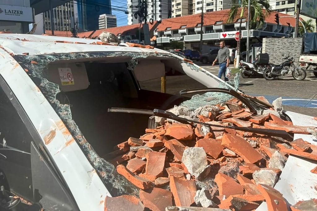 A vehicle damaged by debris sits on a street in Panama City on Friday. Photo: EPA