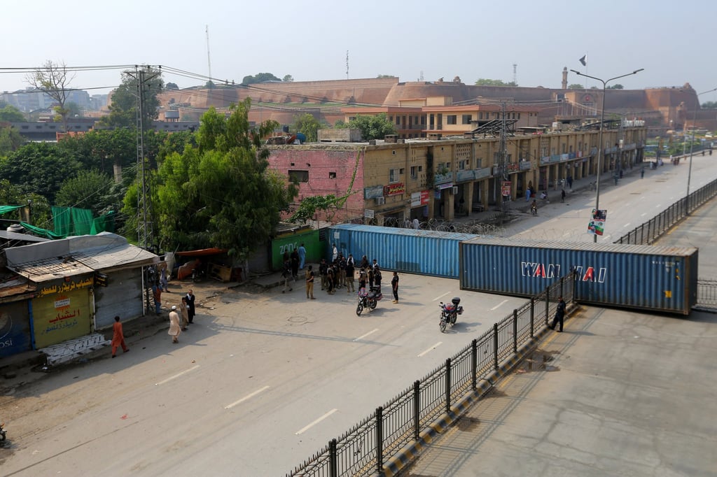 Shipping containers block roads in Peshawar on Sunday. Photo: EPA