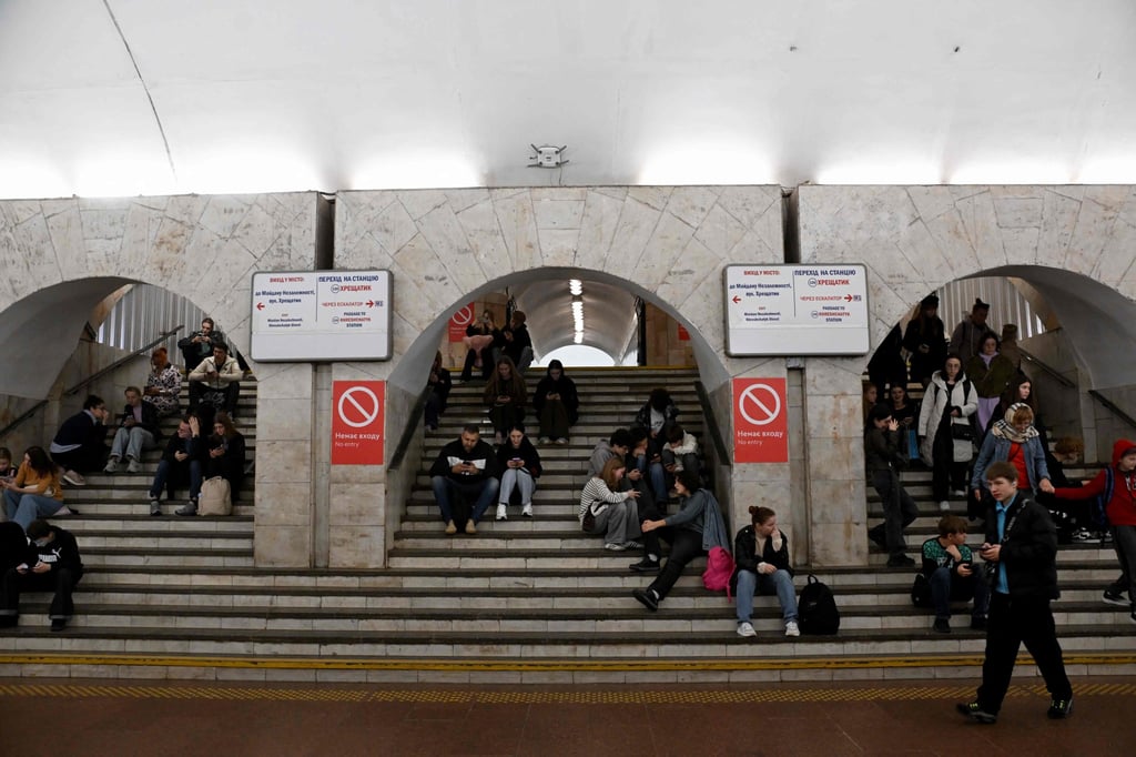 People shelter in a metro station during air strikes in Kyiv on Saturday. Photo: AFP