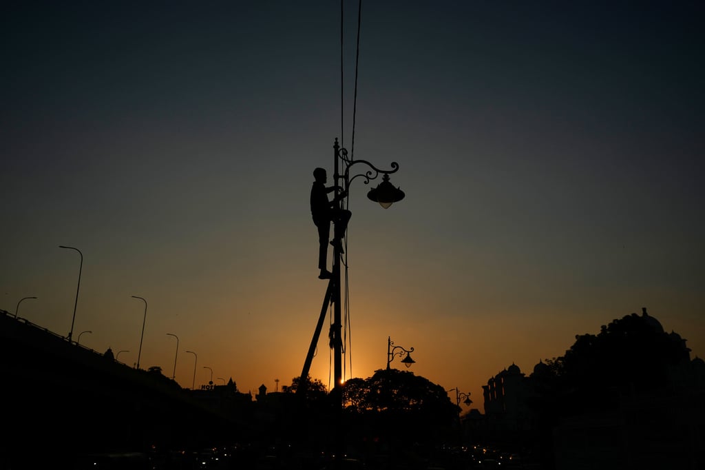 A man works on the electricity supply in Hyderabad, India on October 2. Photo: AP