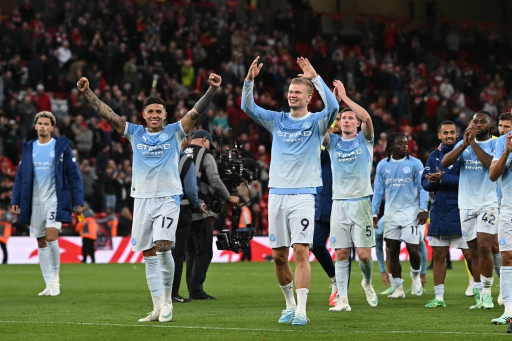 Manchester City’s players celebrate on the pitch after their match against Liverpool at Anfield on Sunday. Photo: AFP