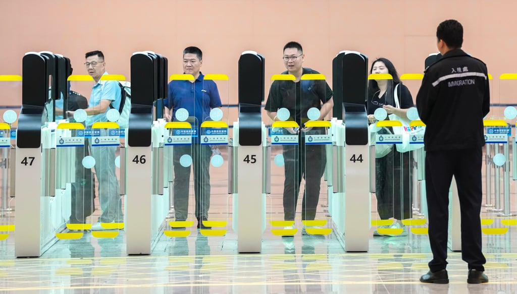 Travellers pass through the automated three-stage gates. Photo: Karma Lo