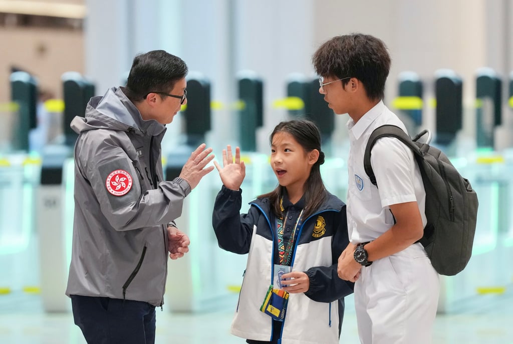 Secretary for Security Chris Tang (left) welcomes inbound travellers. Photo: Karma Lo