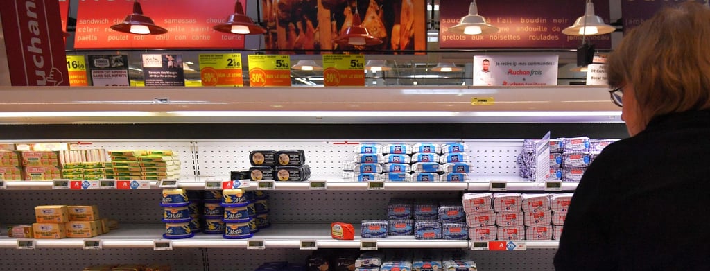 A woman looks at a refrigerated supermarket shelf in Saint-Sebastien-sur-Loire in western France. File photo: AFP