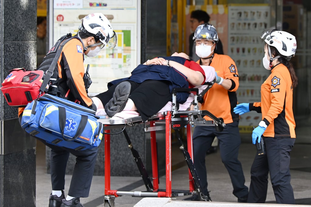 Rescuers carry an injured person outside a shopping centre following a stabbing attack in Incheon, South Korea, on Tuesday. Photo: AP