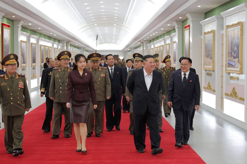 Kim Jong-un and his daughter Ju-ae walk along a corridor lined with photographs during their tour of the National Defence Revolution Museum. Photo: KCNA/AFP Kim Jong-un and his daughter Ju-ae walk along a corridor lined with photographs during their tour of the National Defence Revolution Museum. Photo: KCNA/AFP