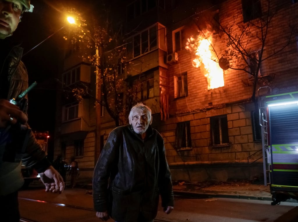 A resident stands outside a building damaged during a Russian drone strike in Kharkiv, Ukraine on Monday. Photo: Reuters