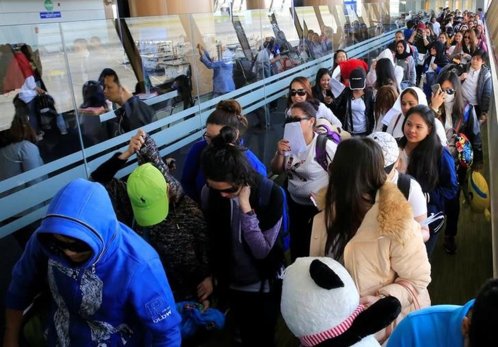 Overseas Filipino workers from Kuwait arrive at the Ninoy Aquino International Airport in 2018. As of July, the Philippines had brought home more than 12,000 Filipinos from the Middle East this year. Photo: Reuters