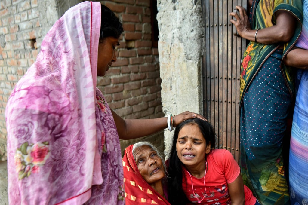 Family members mourn the death of a relative after the boat capsized in India’s Bihar state on Wednesday. Photo: AFP