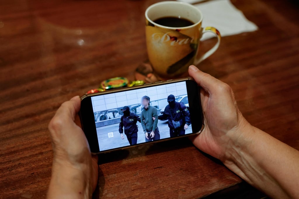A person watches a news feed running FSB footage of the operation to detain a Japanese journalist in Moscow on Tuesday. Photo: AFP A person watches a news feed running FSB footage of the operation to detain a Japanese journalist in Moscow on Tuesday. Photo: AFP