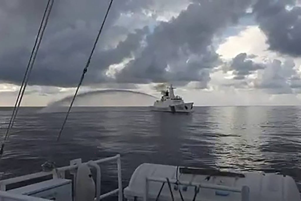 A Chinese coastguard ship fires its water cannon next to a Philippine coastguard ship during a medical evacuation of a Philippine Navy sailor near Second Thomas Shoal in the disputed South China Sea last week. Photo: AFP/Philippine coastguard