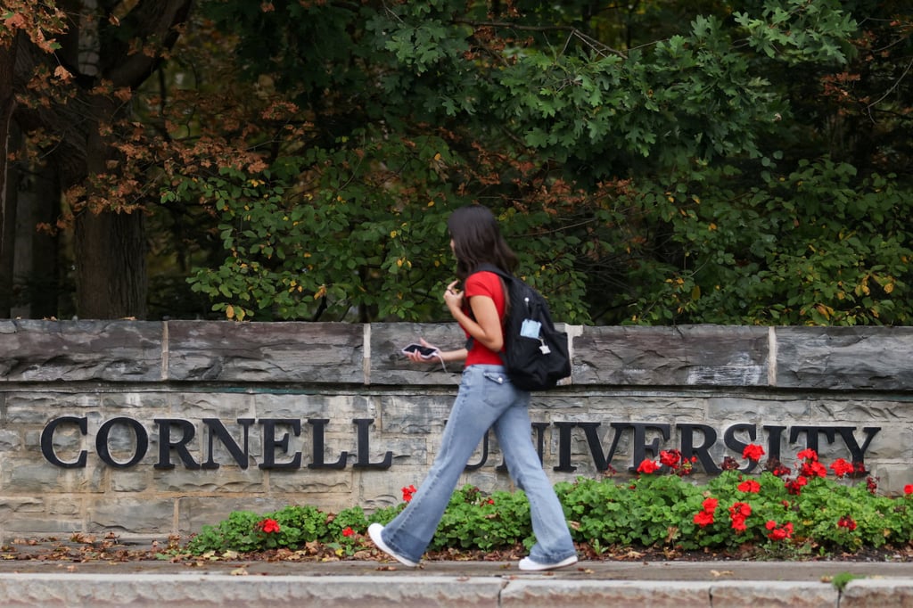 A student walks by the entrance of Cornell University. Photo: Reuters