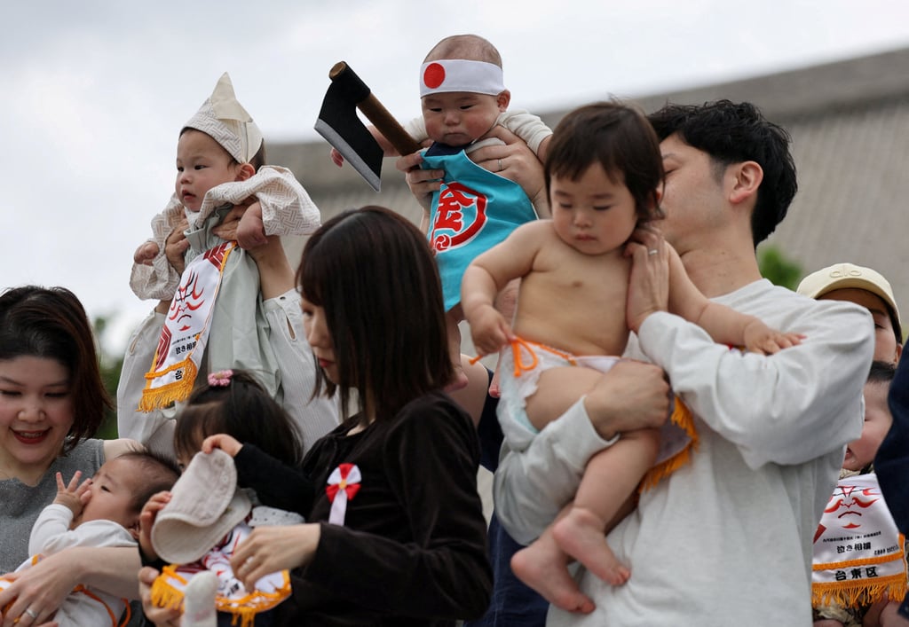 Babies and their parents take part in a ring-entering ceremony during “Nakizumo” or a baby-crying sumo contest, where two wrestlers hold a baby each and a referee makes faces and loud noises to make them cry, at Sensoji temple in Tokyo, Japan, on April 25. The ritual is believed to aid the healthy growth of the children and ward off evil spirits. Photo: Reuters Babies and their parents take part in a ring-entering ceremony during “Nakizumo” or a baby-crying sumo contest, where two wrestlers hold a baby each and a referee makes faces and loud noises to make them cry, at Sensoji temple in Tokyo, Japan, on April 25. The ritual is believed to aid the healthy growth of the children and ward off evil spirits. Photo: Reuters