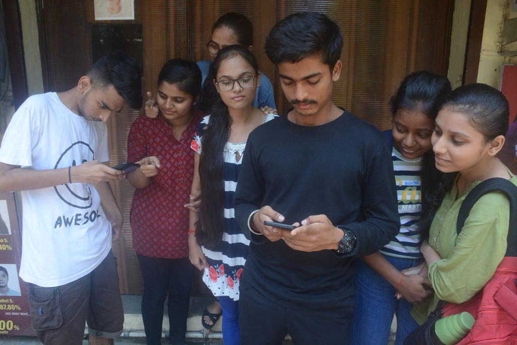 Indian students checking their exam results online on their mobile phones in Mumbai. Lawyers say enforcement of a proposed social media ban for Indian users below 18 would be challenging. Photo: Hindustan Times/Getty Images Indian students checking their exam results online on their mobile phones in Mumbai. Lawyers say enforcement of a proposed social media ban for Indian users below 18 would be challenging. Photo: Hindustan Times/Getty Images