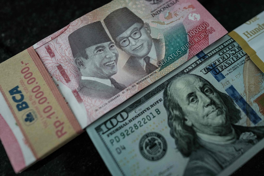 Indonesian rupiah banknotes are pictured next to US dollar banknotes at a currency exchange office in Jakarta earlier this year. Photo: AFP