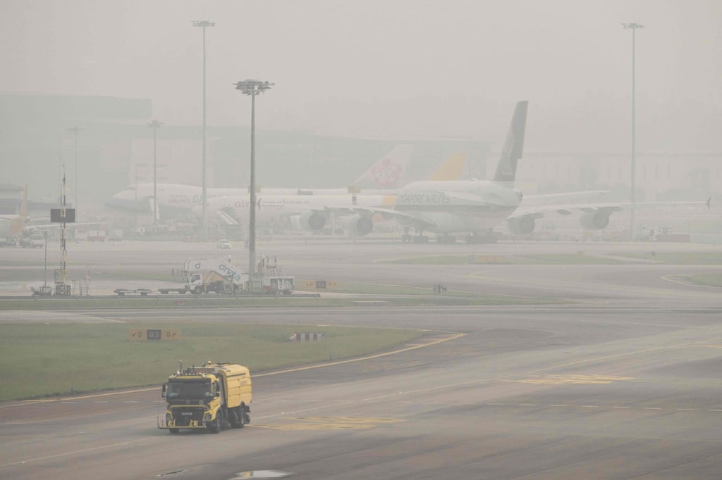 The tarmac at Changi Airport in Singapore is shrouded in haze on Friday. Photo: AFP The tarmac at Changi Airport in Singapore is shrouded in haze on Friday. Photo: AFP