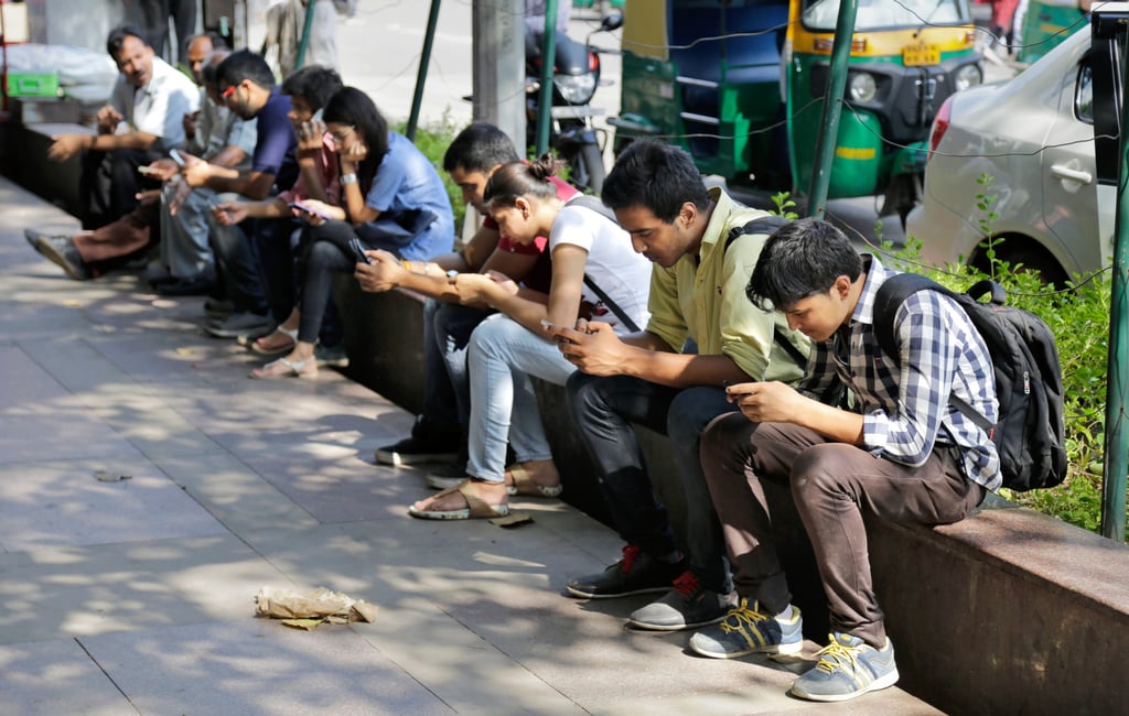Indians use their mobile phones in New Delhi. A proposed social media ban for Indian users below 18 is partly aimed at curbing the mental health impact from excessive use. Photo: AP Indians use their mobile phones in New Delhi. A proposed social media ban for Indian users below 18 is partly aimed at curbing the mental health impact from excessive use. Photo: AP