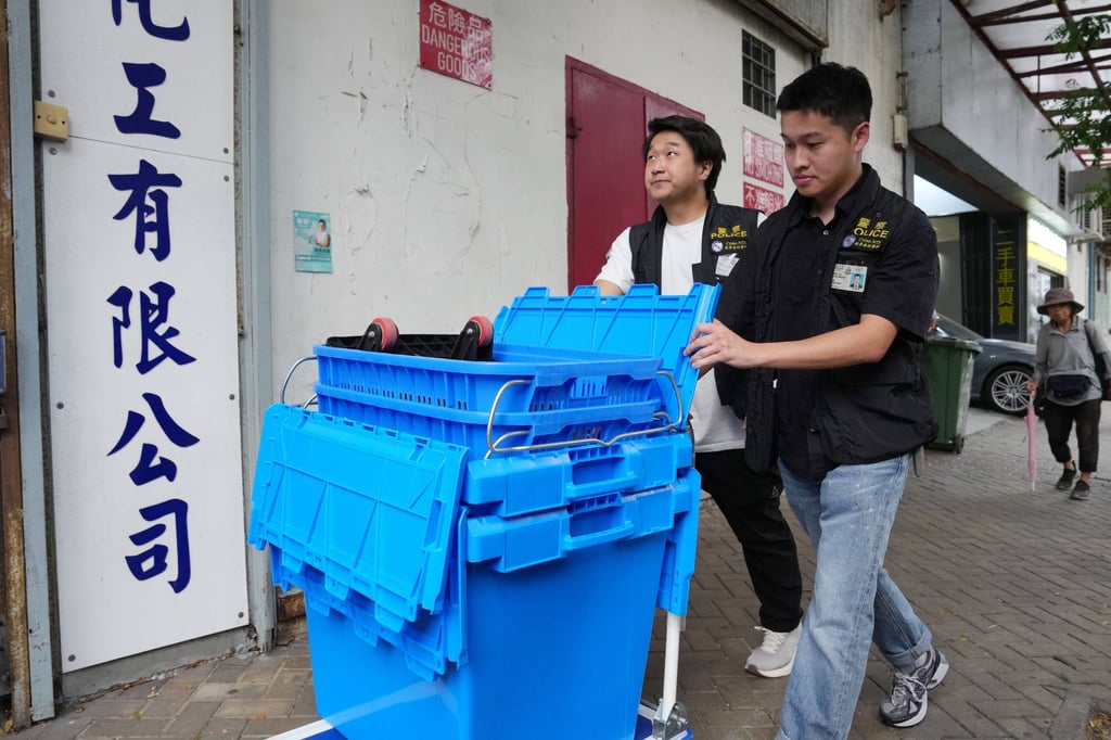 Police officers carry out the raid on the company’s office. Photo: Kit Lai Police officers carry out the raid on the company’s office. Photo: Kit Lai