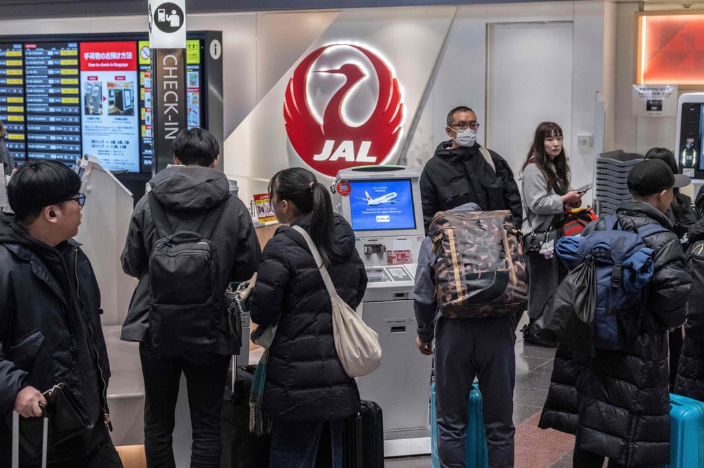 People wait to check in at a counter for Japan Airlines at the departures hall of Haneda Airport in Tokyo. Abuse cases targeted at airline staff in Japan have risen over the past year, a survey shows. Photo: AFP People wait to check in at a counter for Japan Airlines at the departures hall of Haneda Airport in Tokyo. Abuse cases targeted at airline staff in Japan have risen over the past year, a survey shows. Photo: AFP