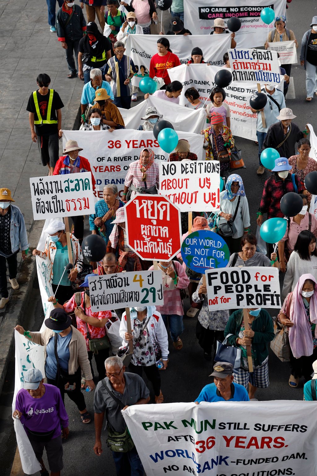 Thai protesters hold banners during a march near the venue of the Annual Meetings of the IMF and World Bank Group in Bangkok on Thursday. Photo: EPA Thai protesters hold banners during a march near the venue of the Annual Meetings of the IMF and World Bank Group in Bangkok on Thursday. Photo: EPA