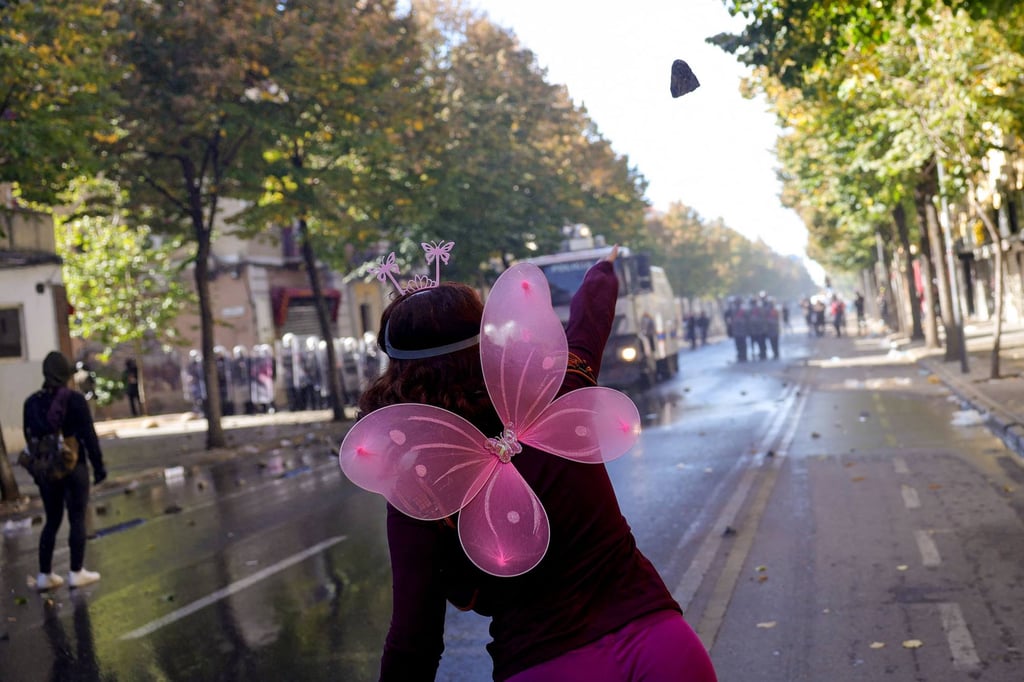 A protester throws a cobblestone in central Tirana on Saturday. Photo: AFP A protester throws a cobblestone in central Tirana on Saturday. Photo: AFP