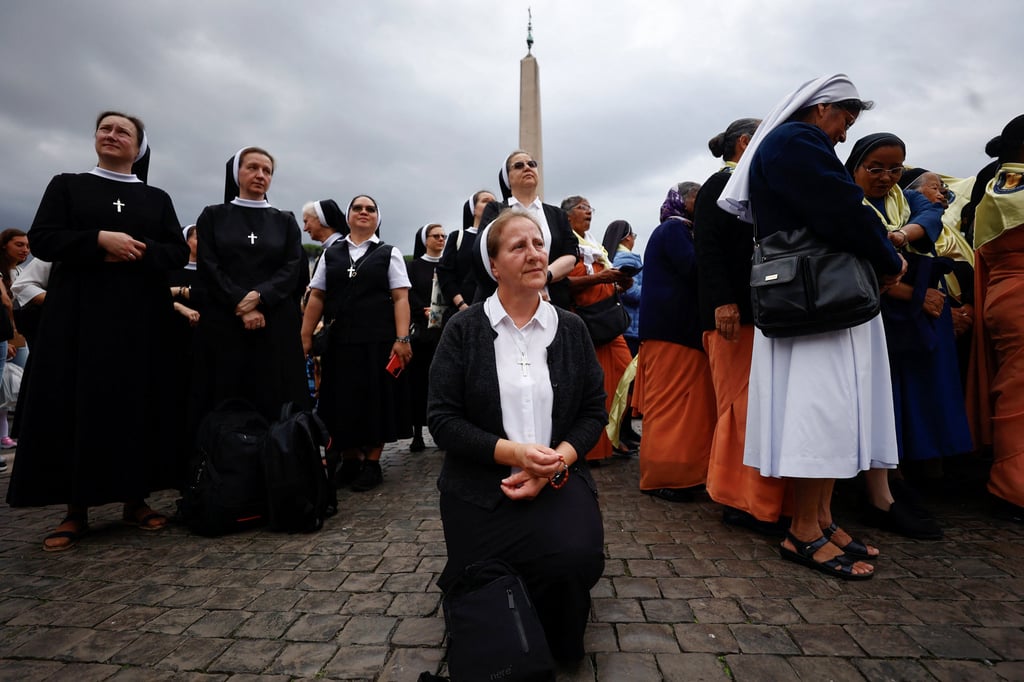 Nuns gather in St. Peter’s Square before Pope Leo leads the Angelus prayer from a window of the Apostolic Palace, following his discharge from hospital after surgery for lung cancer, at the Vatican, on Sunday. Photo: Reuters