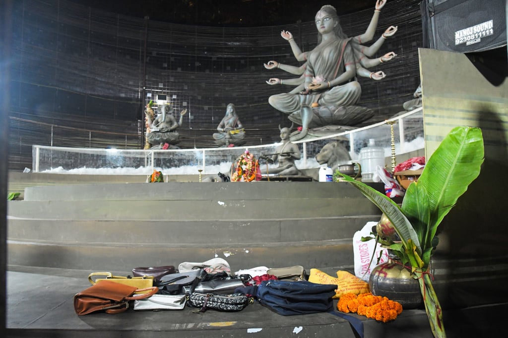 Purses and other belongings left behind by devotees lie on the floor of a worship venue on Saturday, following a stampede. Photo: AP Purses and other belongings left behind by devotees lie on the floor of a worship venue on Saturday, following a stampede. Photo: AP
