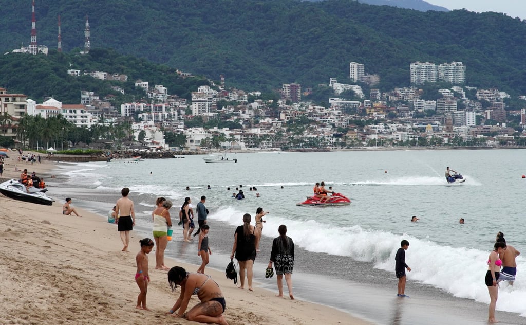 Tourists remain on a beach in Puerto Vallarta, Jalisco state, Mexico, on Saturday. Photo: EPA