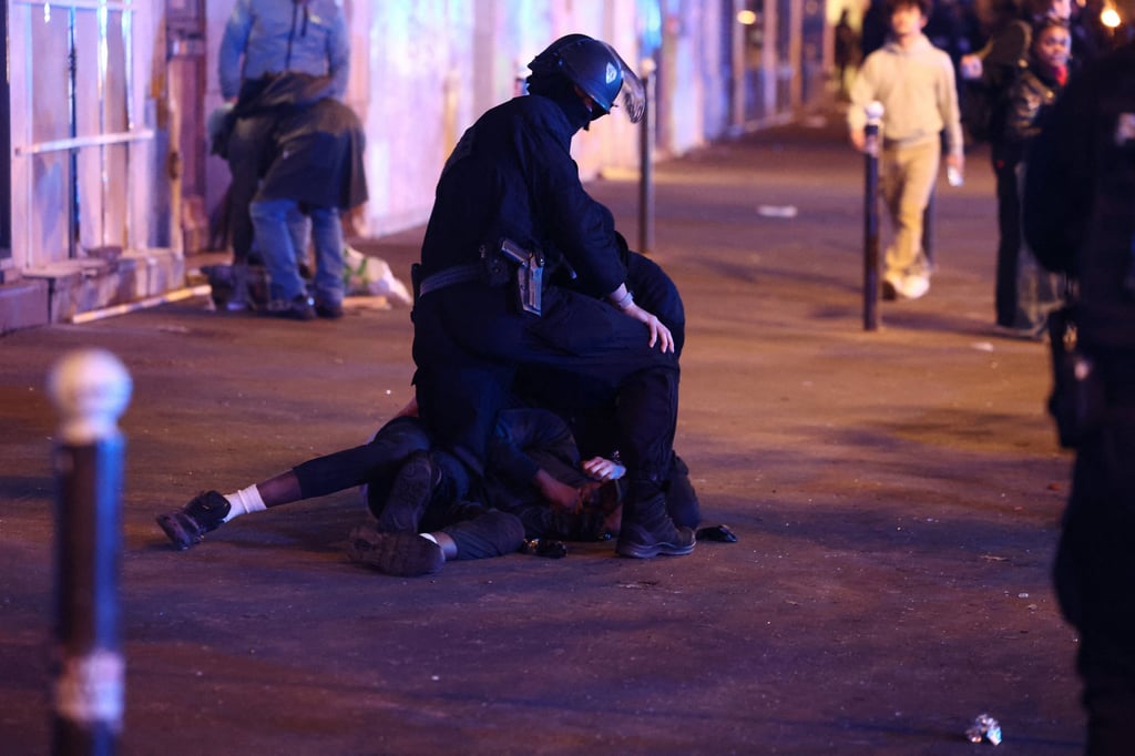 A protester is detained in Paris on Sunday. Photo: Reuters A protester is detained in Paris on Sunday. Photo: Reuters