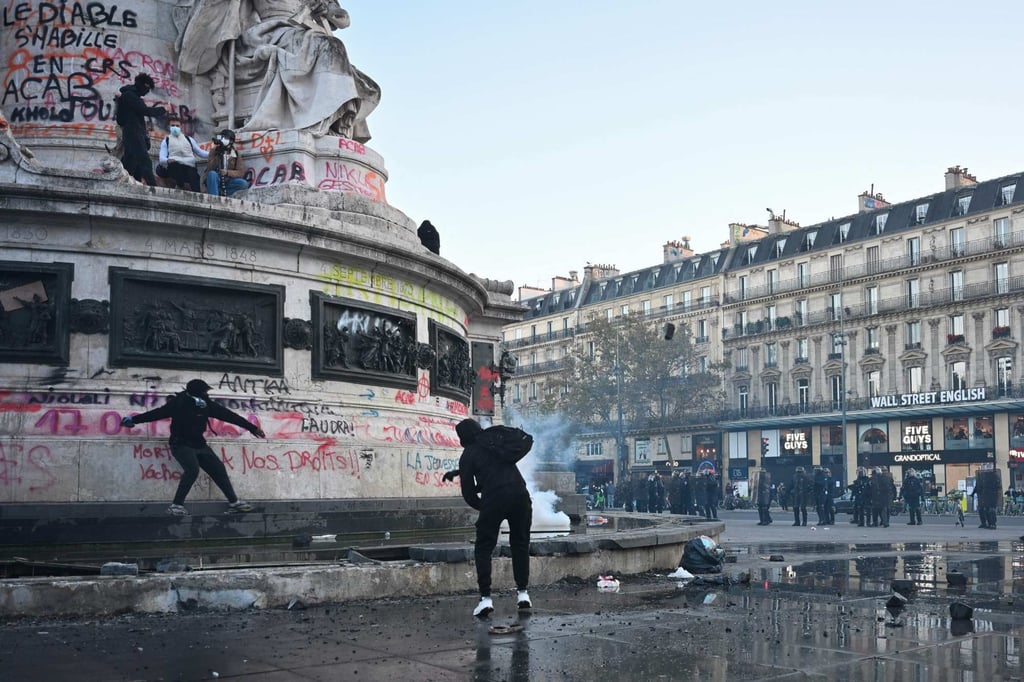 Protesters break up the fountain at the base of the Statue de La Republique to get stones as clashes erupted at Place de la Republique in central Paris on Sunday. Photo: AFP