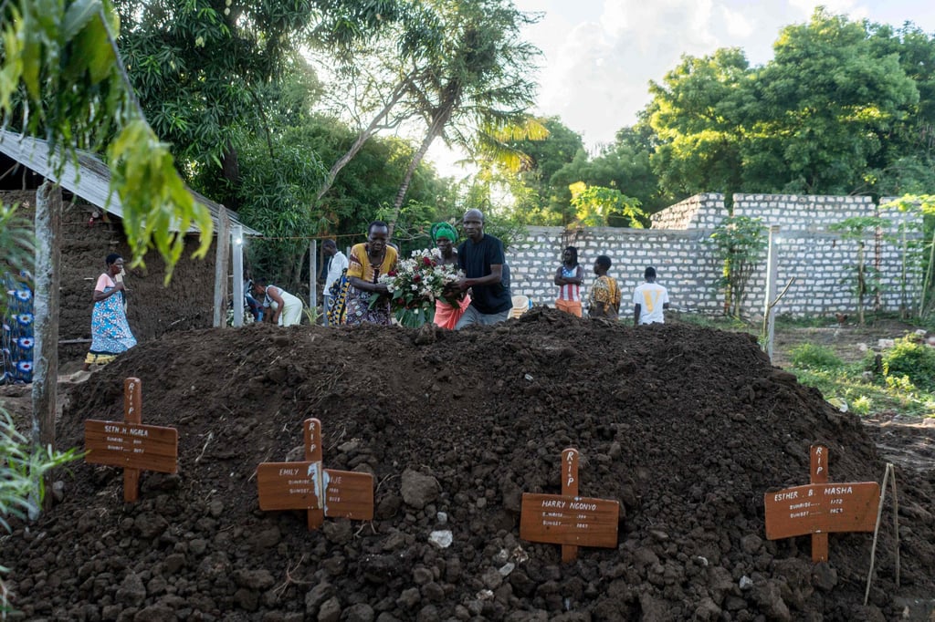 Family members and relatives place flowers on the grave of victims of the Shakahola massacre, in Malindi, in 2023. Photo: AFP Family members and relatives place flowers on the grave of victims of the Shakahola massacre, in Malindi, in 2023. Photo: AFP
