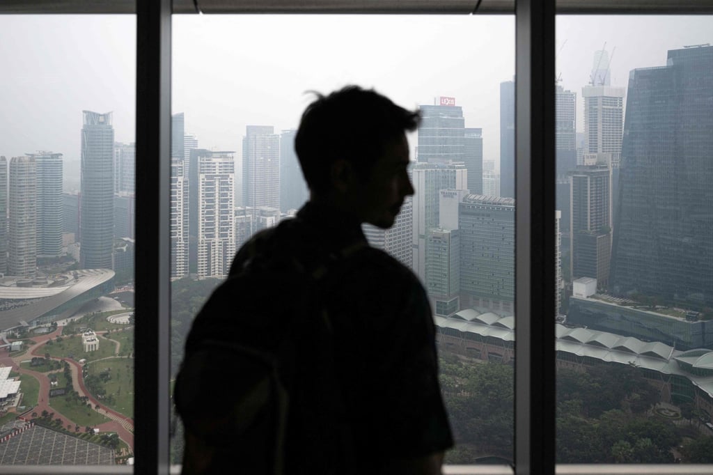 A man looks at high-rise buildings shrouded in haze in Kuala Lumpur on Monday. Photo: AFP