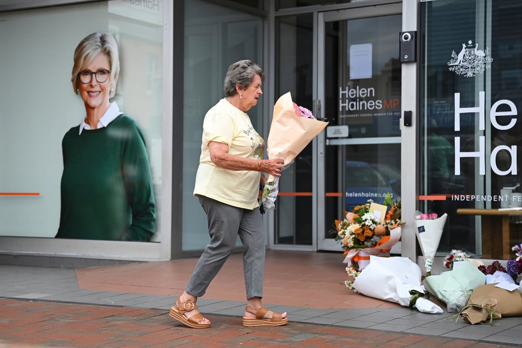 A woman delivers flowers at the electoral office of lawmaker Helen Haines in Wangaratta, Australia, on Tuesday. Photo: AAP Image via AP