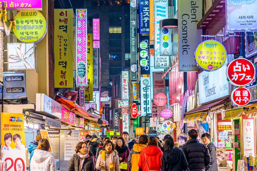 People walk along the Myeongdong district in Seoul. Photo: Shutterstock