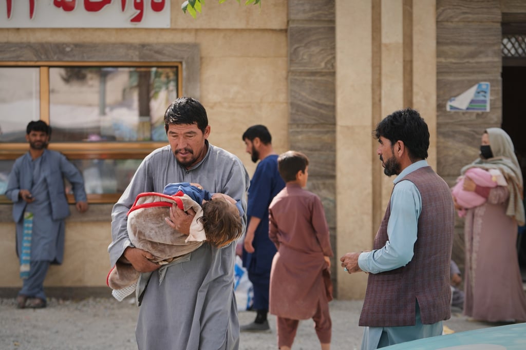 A man carries a child wrapped in a blanket outside a children’s hospital in Kabul, Afghanistan. Photo: AP A man carries a child wrapped in a blanket outside a children’s hospital in Kabul, Afghanistan. Photo: AP