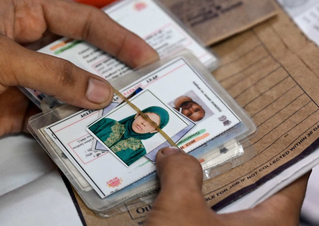 A man waits with documents to register for the draft electoral roll in Delhi on Sunday. Photo: AFP A man waits with documents to register for the draft electoral roll in Delhi on Sunday. Photo: AFP