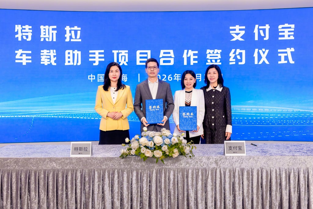 Representatives from Tesla and Alipay announce a deal on in-car digital payment features on Tuesday. Photo: Weibo Representatives from Tesla and Alipay announce a deal on in-car digital payment features on Tuesday. Photo: Weibo
