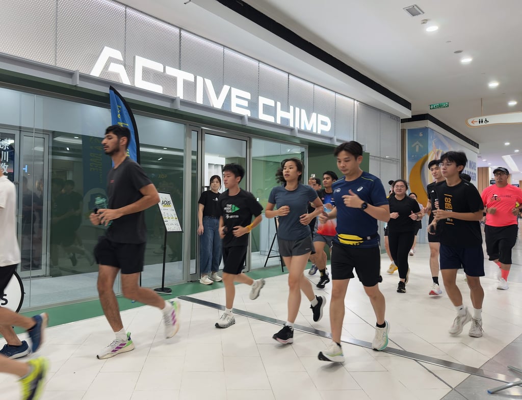 Participants run past The Active Chimp fitness studio at Atria Shopping Gallery in Petaling Jaya on Wednesday, as unhealthy air pollution disrupts outdoor exercise across parts of Malaysia. Photo: Iman Muttaqin Yusof