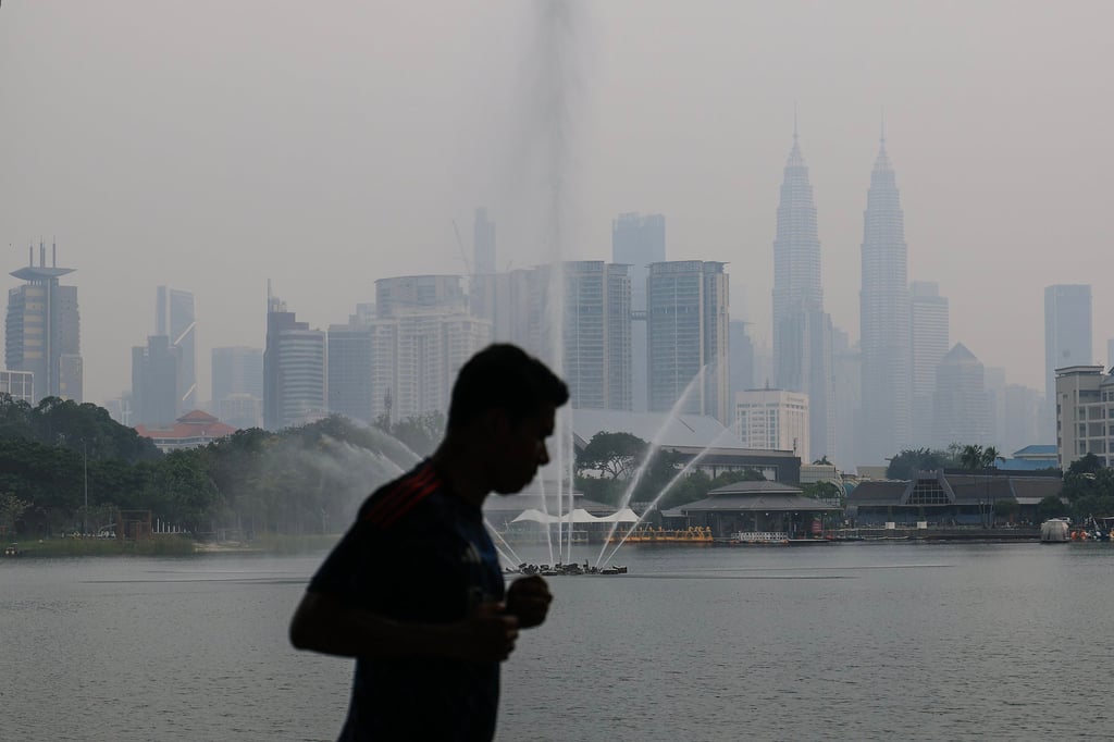A runner is silhouetted against the haze-blanketed Kuala Lumpur skyline on Monday, as air quality reached unhealthy levels. Photo: EPA