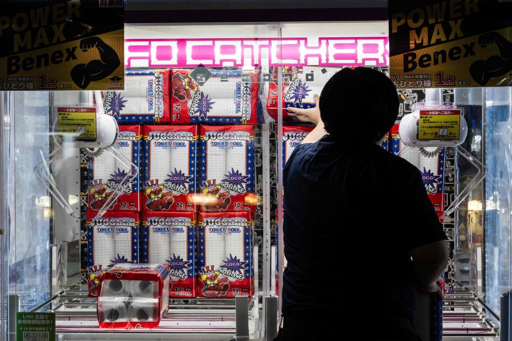 An employee restocks toilet paper at a claw machine game in Kawasaki on October 5. Photo: AFP