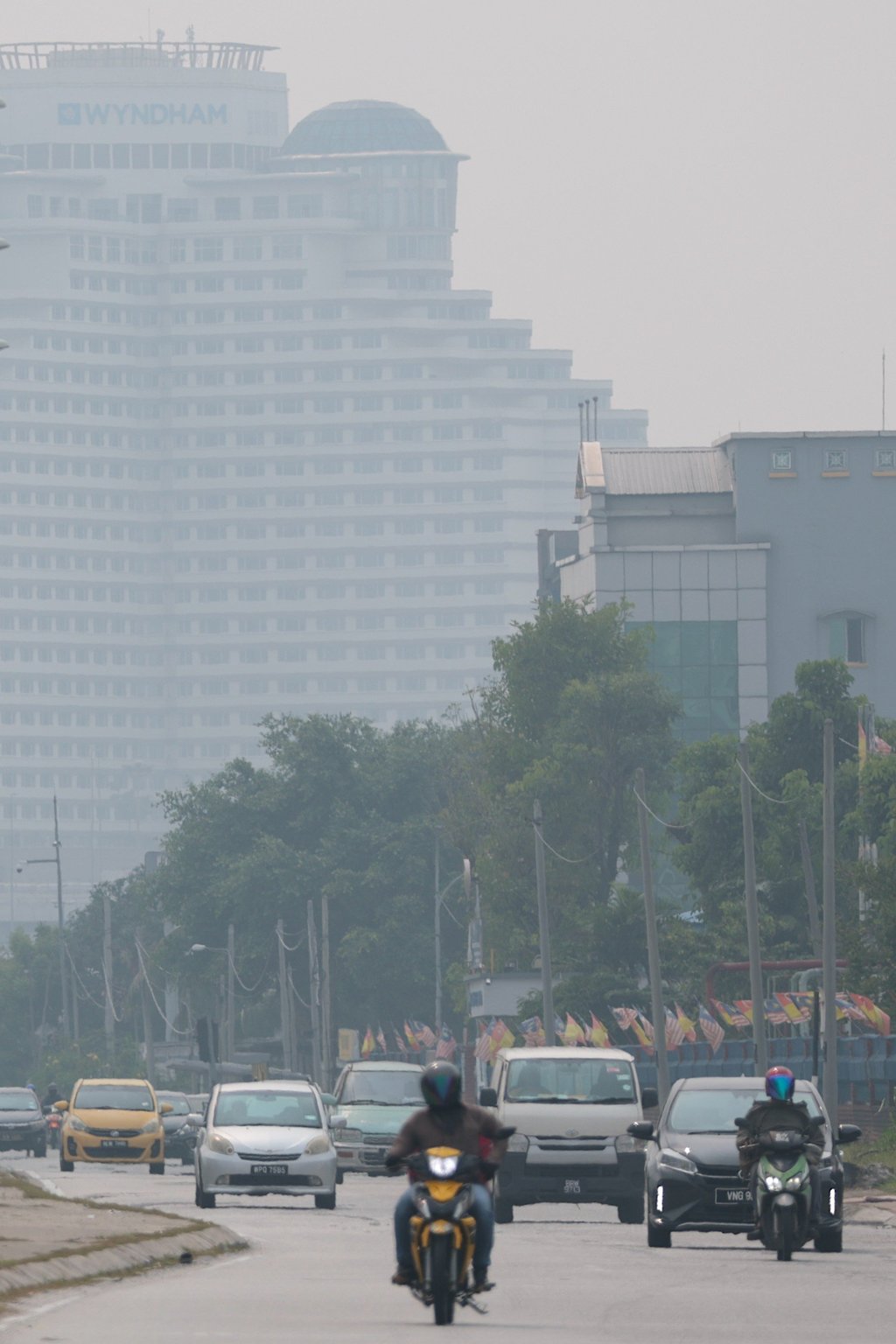 Commuters drive past commercial buildings covered by haze in Shah Alam in Malaysia’s Selangor state on Wednesday. Photo: EPA